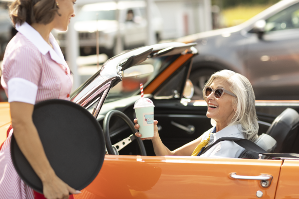 Woman behind the wheel of orange car