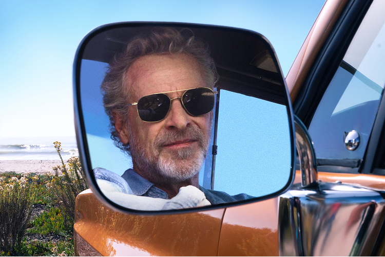 Man looking in side-view mirror