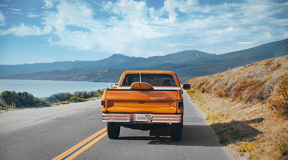 Video_Image of orange pickup truck driving away
